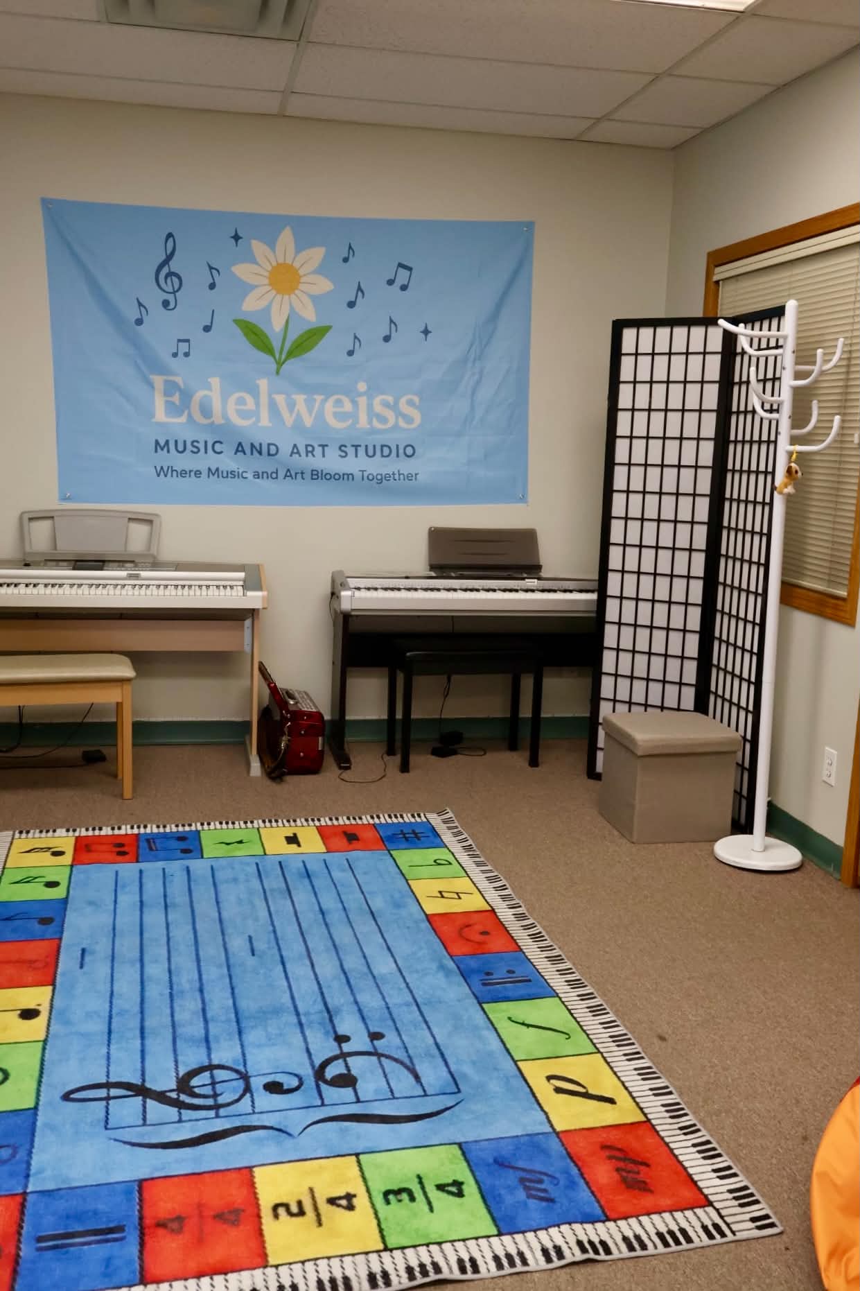 Edelweiss Music & Art Studio teaching room with keyboards and a colourful music rug.