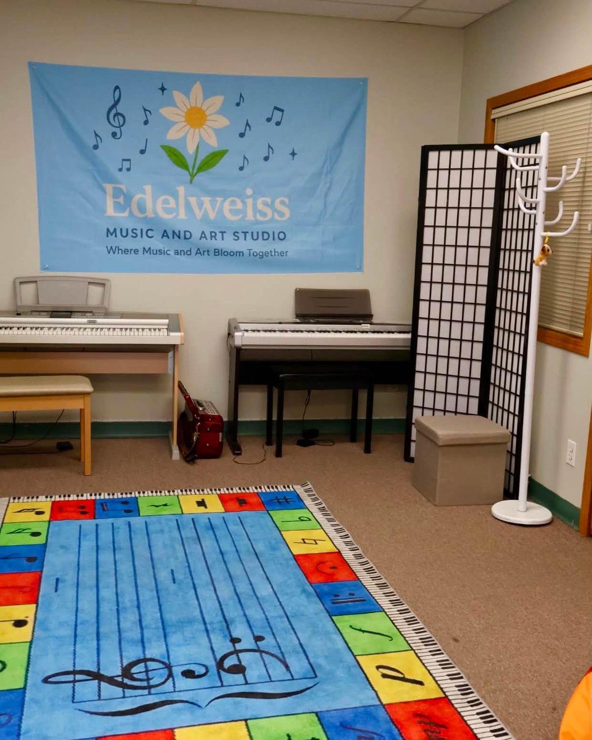 Edelweiss Music & Art Studio teaching room with keyboards and a colourful music rug.