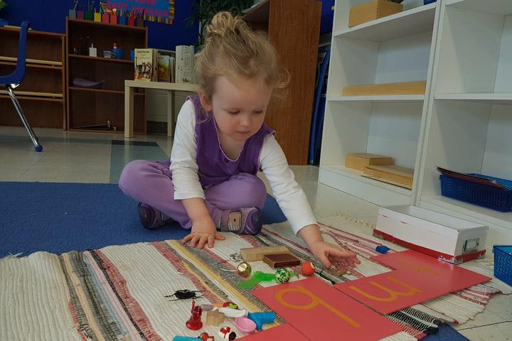 Casa children at work with Montessori materials