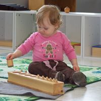 A toddler at work in the Shamrock room at Future Scholars Montessori Academy