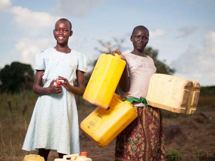 Children carrying water containers