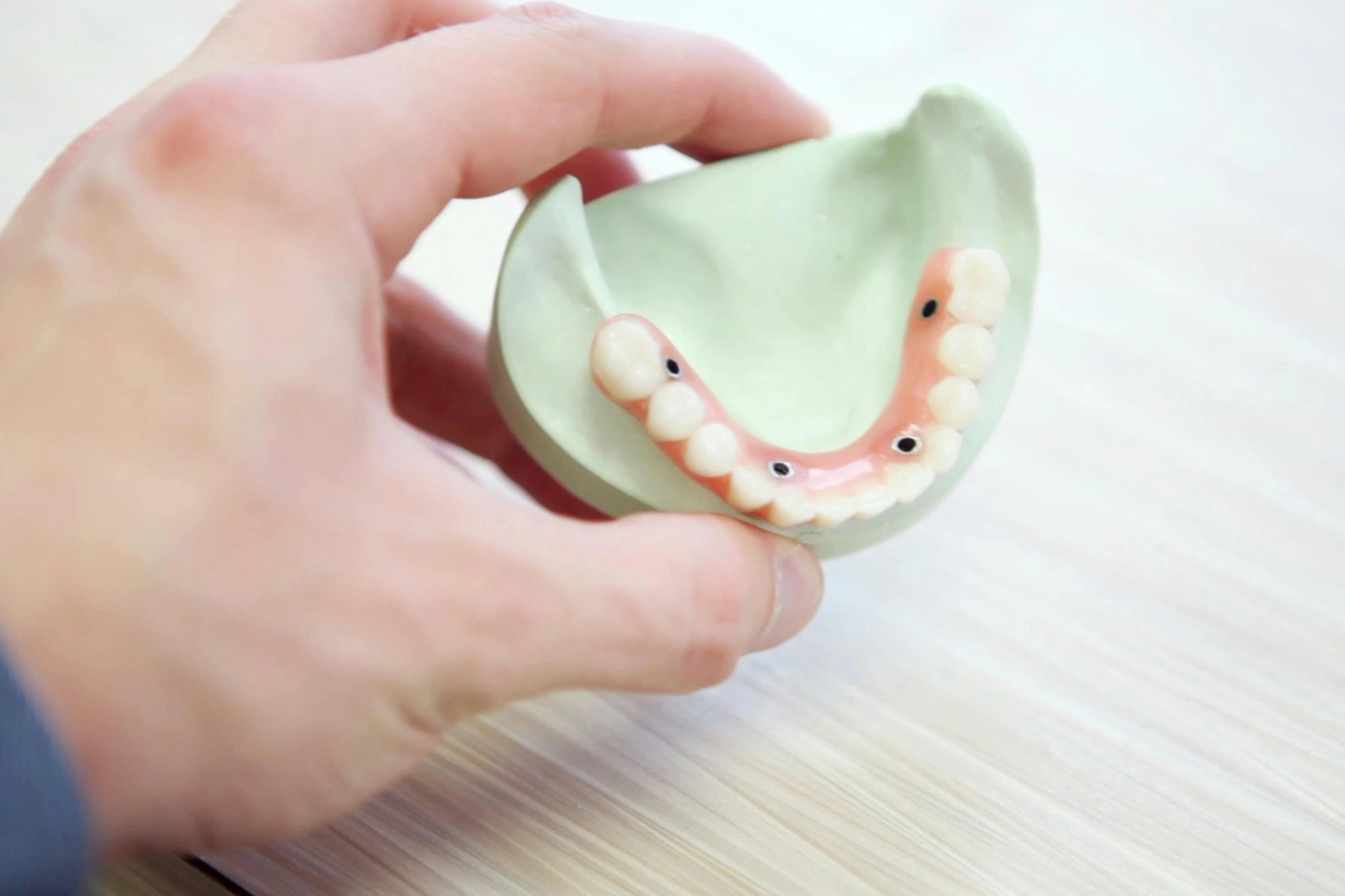 Person holding dentures