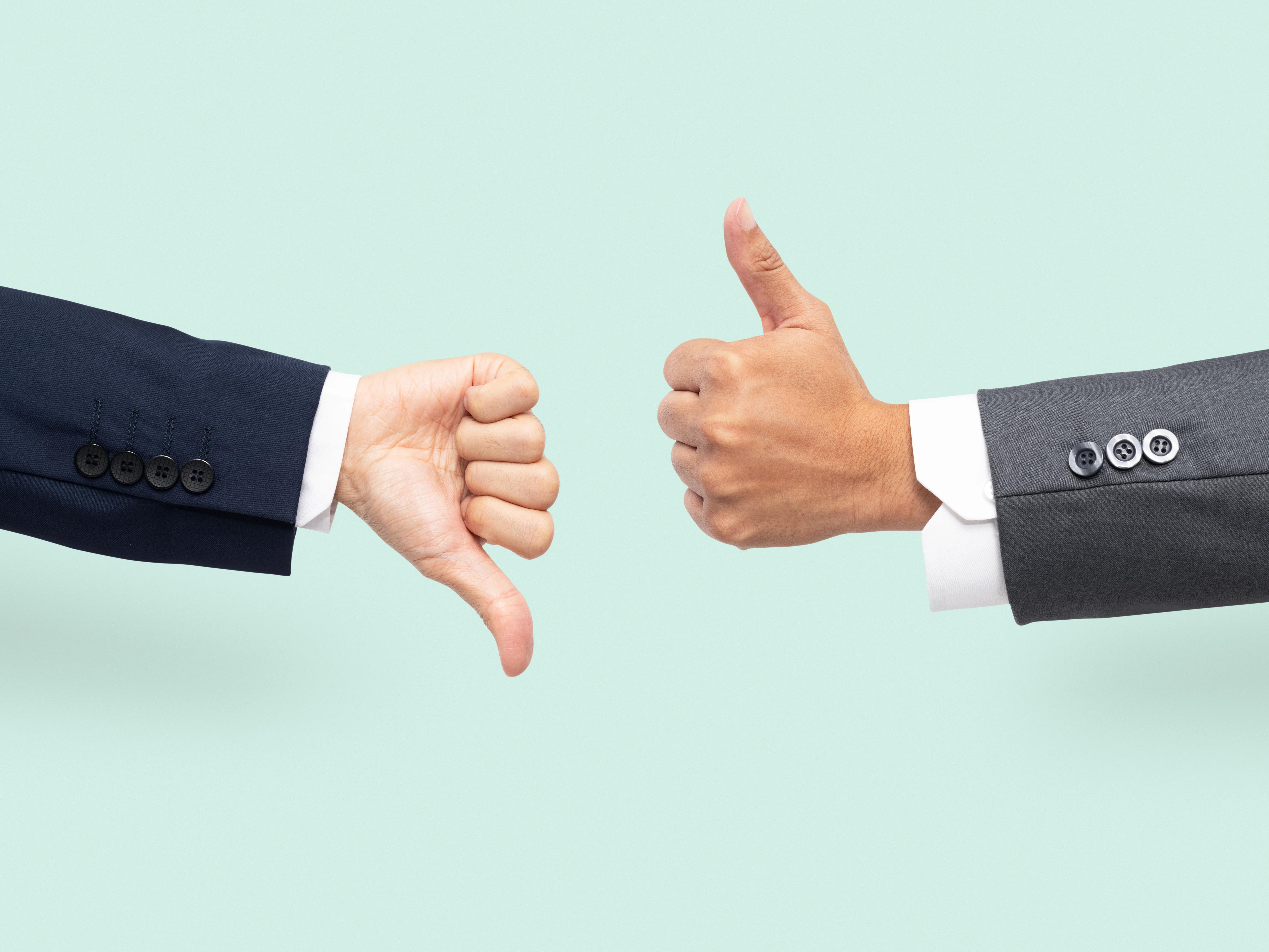 Thumbs up and thumbs down image representing pros and cons of a decision