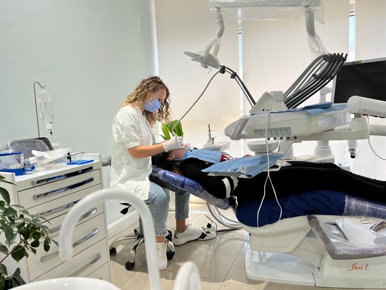 Photo of doctor performing a dental procedure on a patient at Mela Dent Clinic