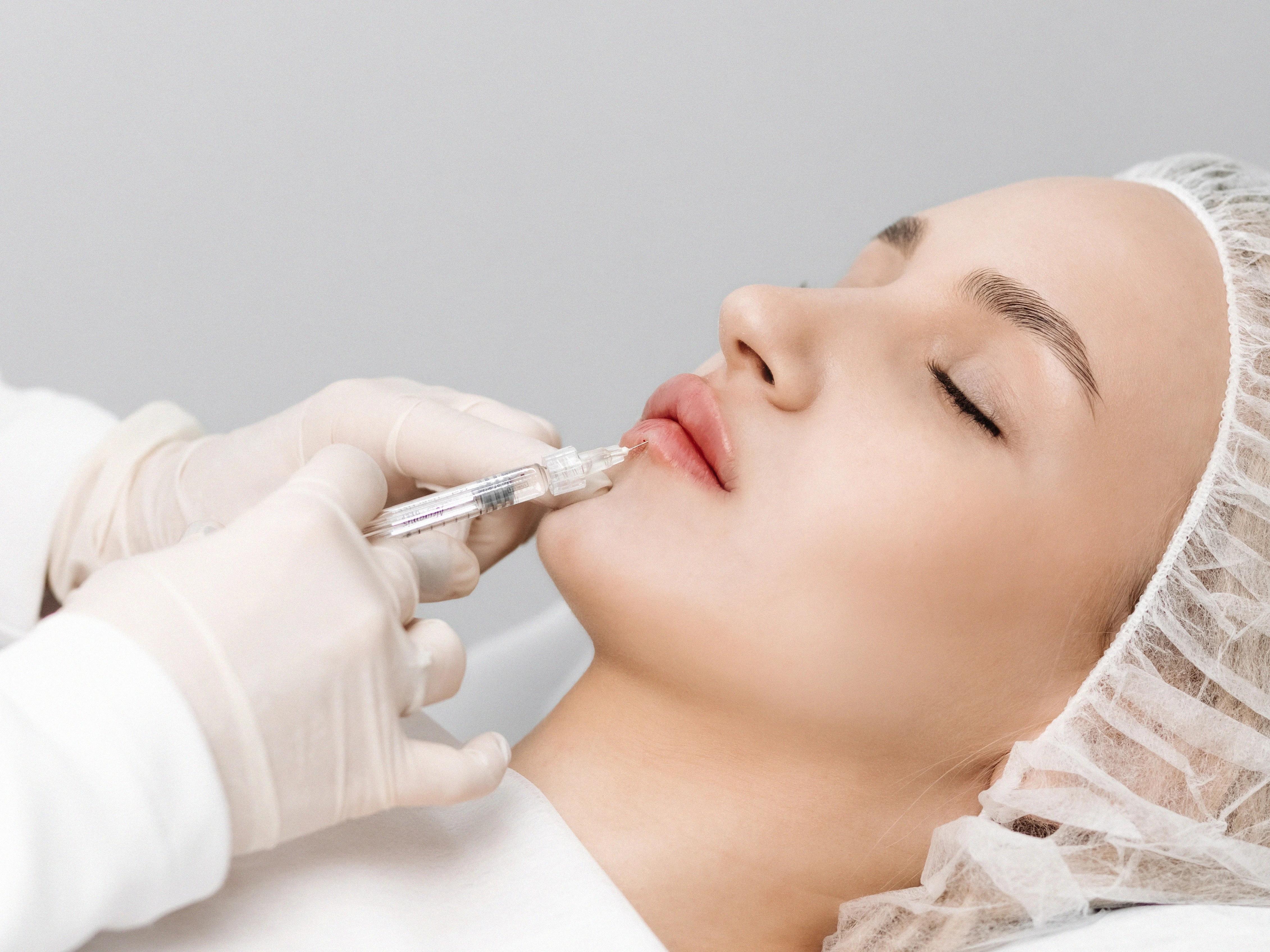 A woman receiving a facial treatment