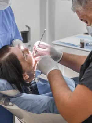 Photo of two doctors performing a dental procedure on a patient at Dental Center Durres