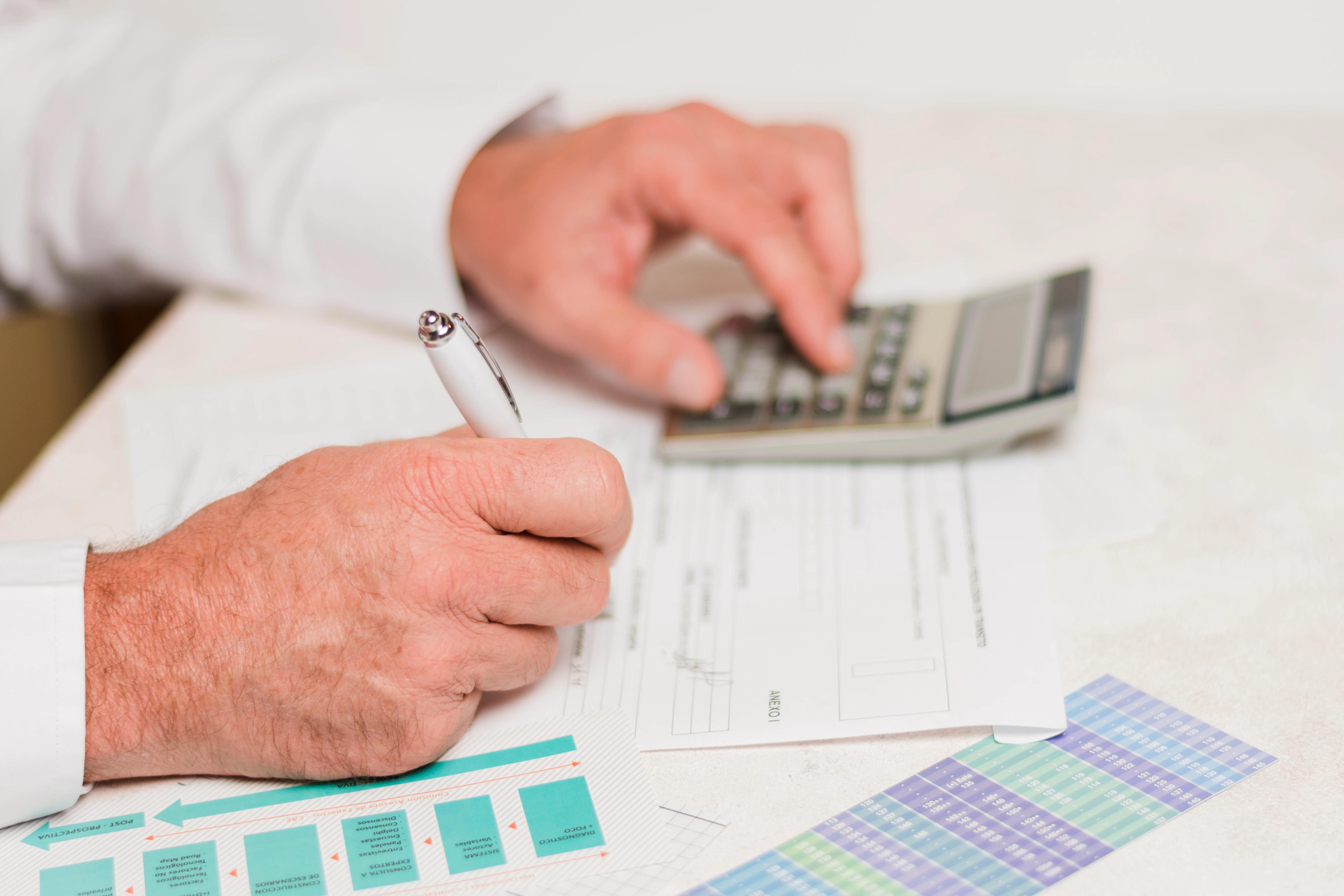 Businessman using calculator