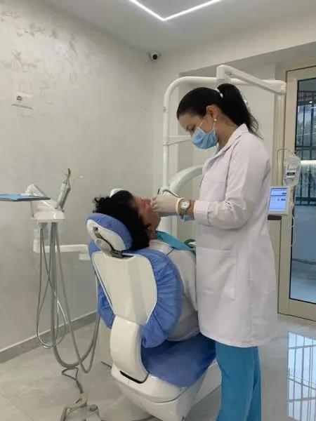 Photo of doctor performing a dental checkup on patient in Deluxe Dental Clinic