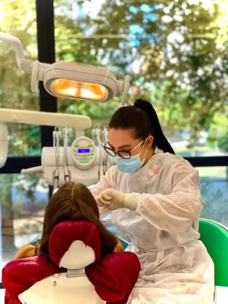 Photo of doctor performing a dental procedure in Dental Artist Clinic