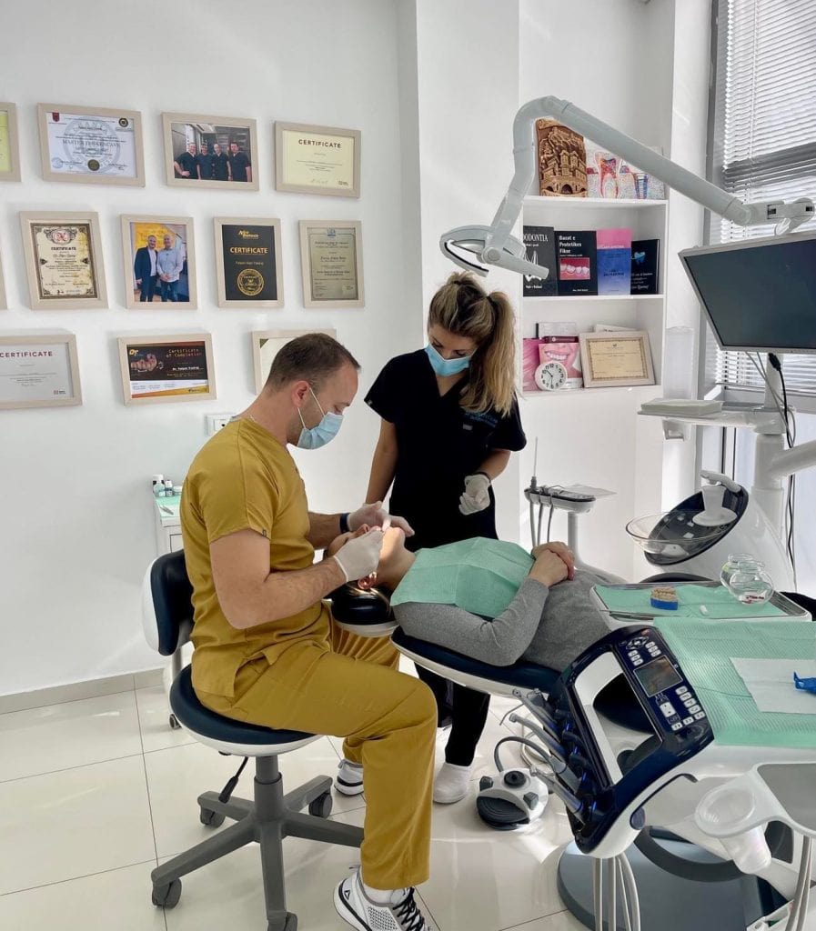 Photo of two doctors performing a dental procedure on a patient at Denton Care Clinic