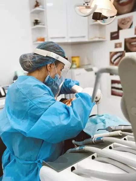 Photo of doctor performing a dental procedure on a patient at Empire Dental Clinic