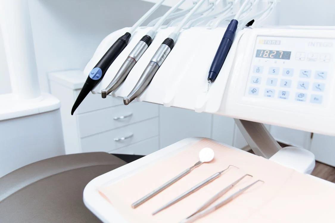 A dental office featuring a dental chair and tools.