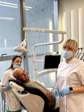 Photo of patient smiling with doctors in Imperial Dental Clinic