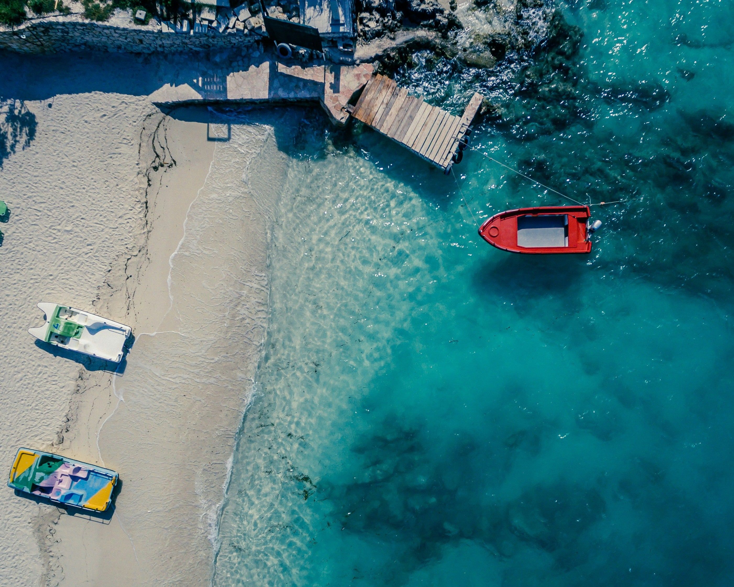  A boat rests on the sandy beach in Ksamil