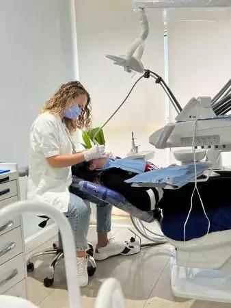 Photo of doctor performing a dental procedure on a patient at Mela Dent Clinic