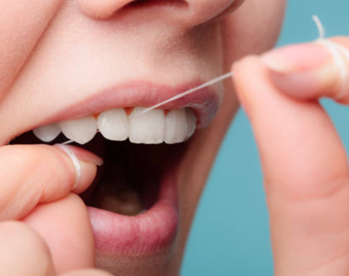 A girl  cleaning her teeth, dental hygiene tips