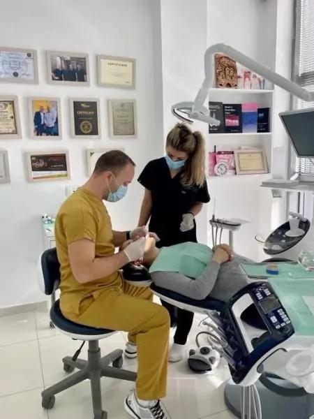 Photo of two doctors performing a dental procedure on a patient at Denton Care Clinic