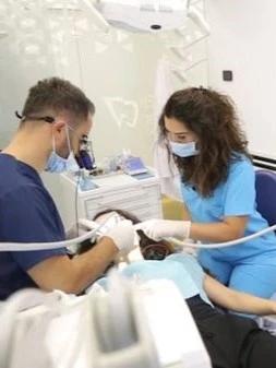 Two doctors performing a dental procedure in Dental Center Albania