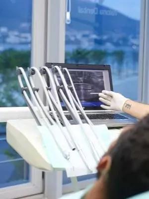 Doctor performing a checkup in Albanian Dental Services