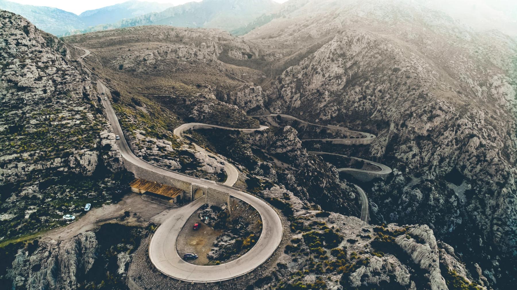 Riders crossing a rocky mountain pass