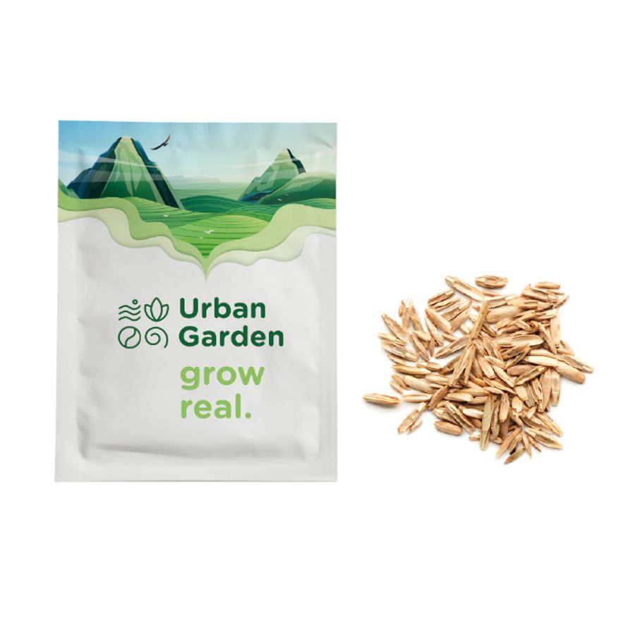 A white paper seed packet with an example print and seeds beside it.