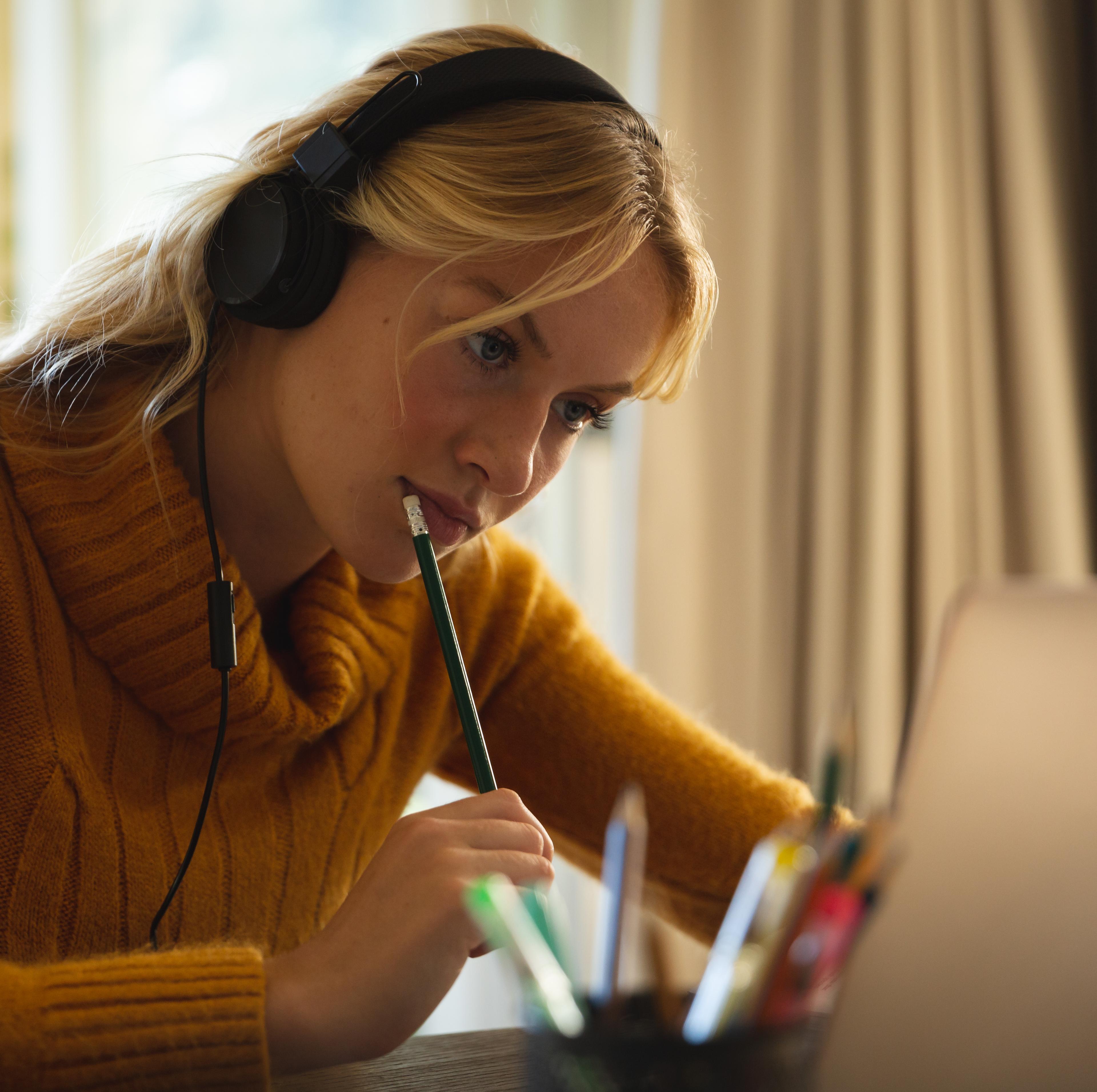 Woman wearing headphones at laptop