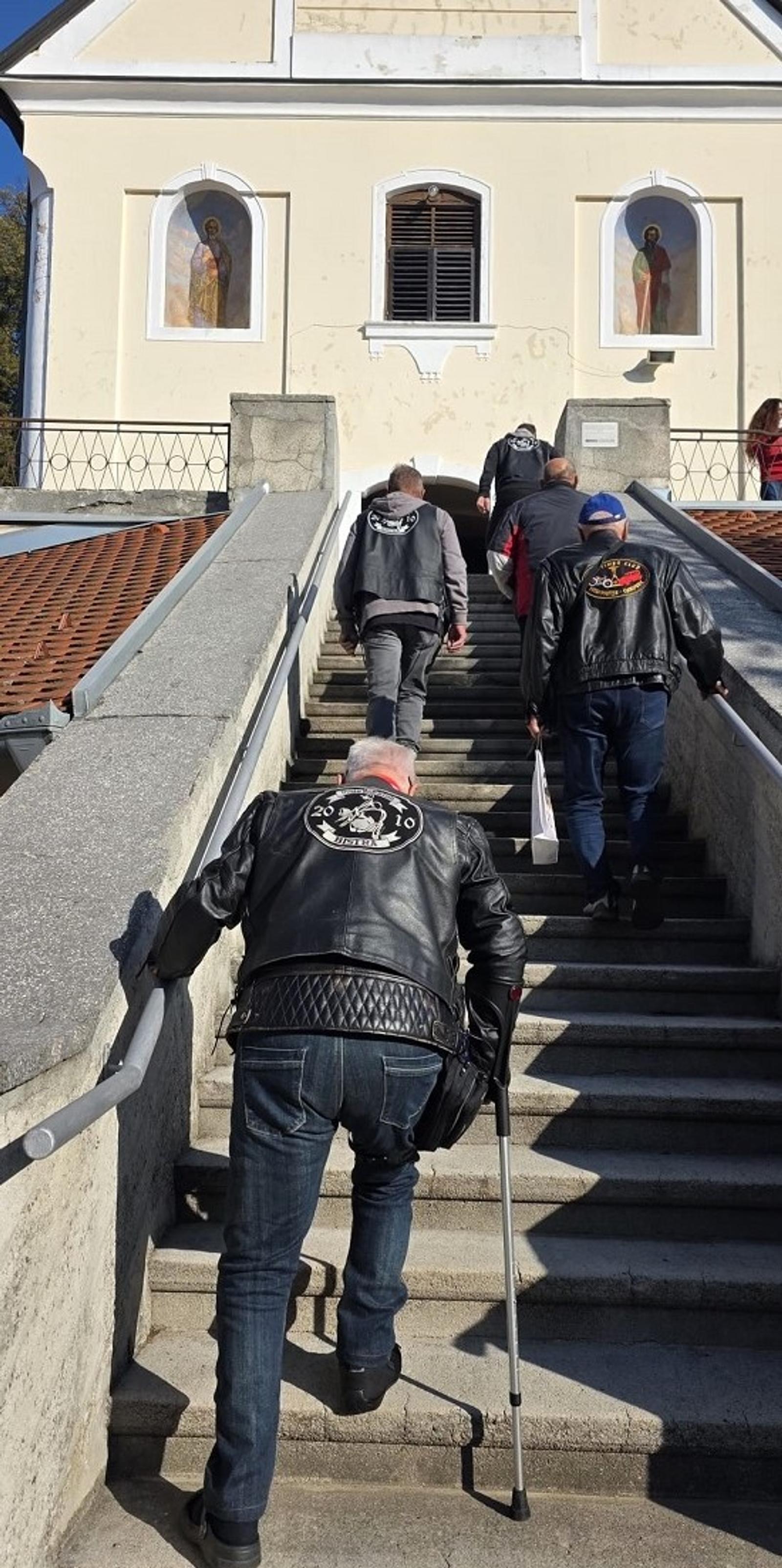 Motoristi se uspinju stubama prema crkvi