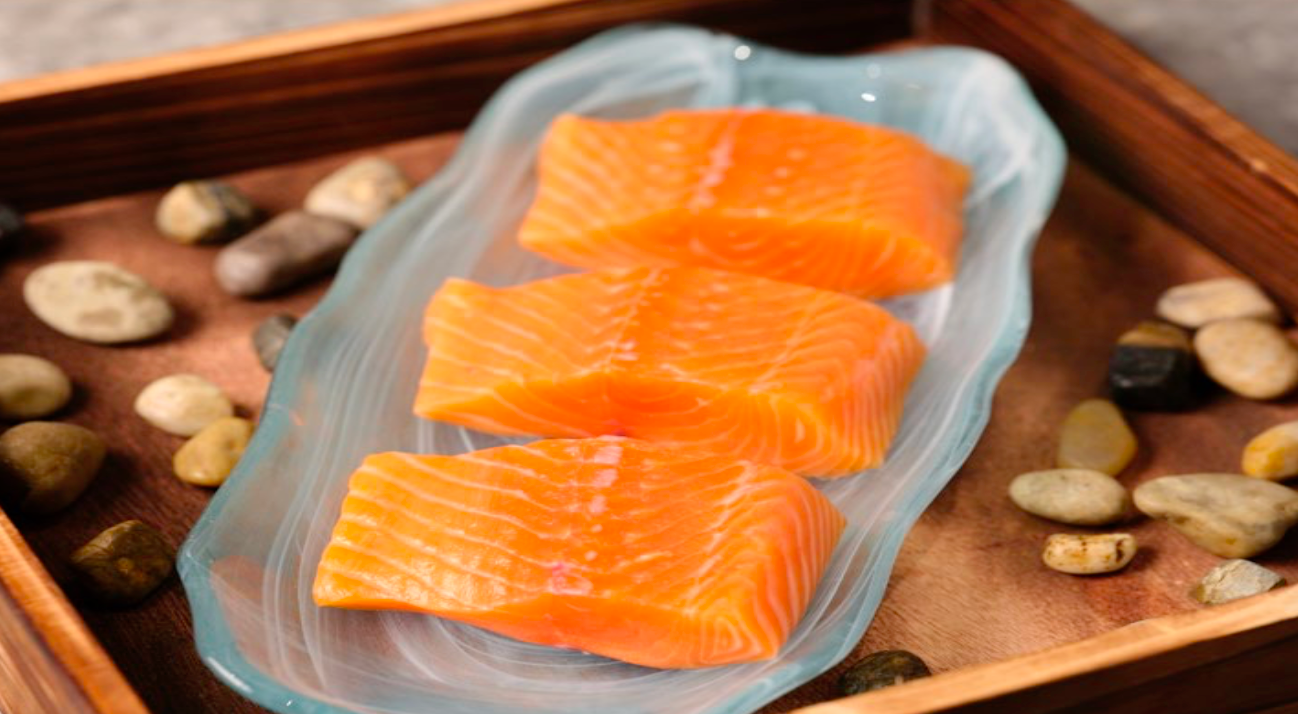 Fresh Canadian-farmed salmon fillets on a serving tray