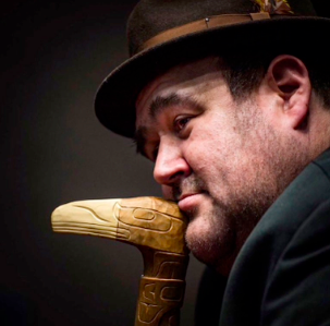 Dallas Smith, spokesperson for the Coalition of First Nations for Finfish Stewardship, in a portrait holding a carved talking stick.