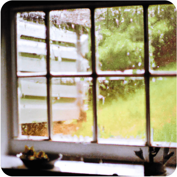 Pouring rain seen through a farmhouse kitchen window, 35mm