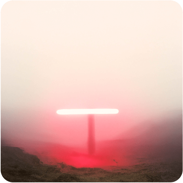 Scene from a memory about a red fluorescent light seen through thick fog in a field