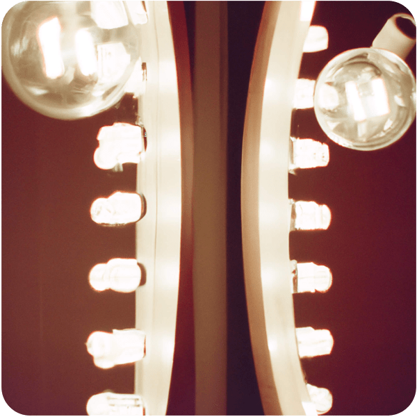 Close up of two lightbulbs around a dressing room mirror at the ballet, 35mm
