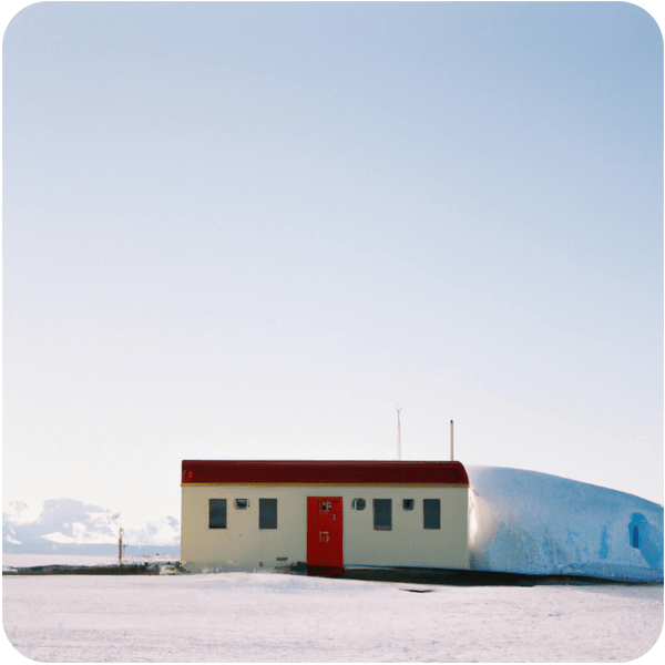 A small post office with red window frames in remote Antarctica seen on a summer’s day, 35mm