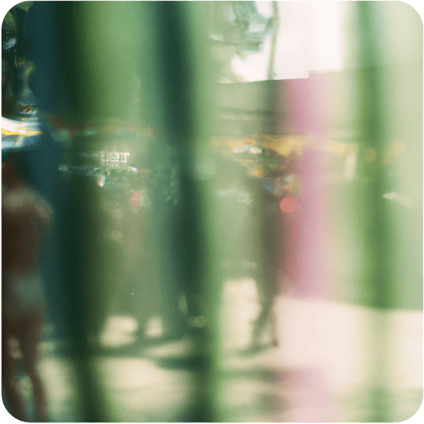 The blur of a happy party in the streets of Brazil seen through a net curtain 