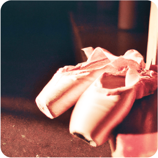 Close up of a pair of ballet shoes backstage at the opera seen in golden hour lighting