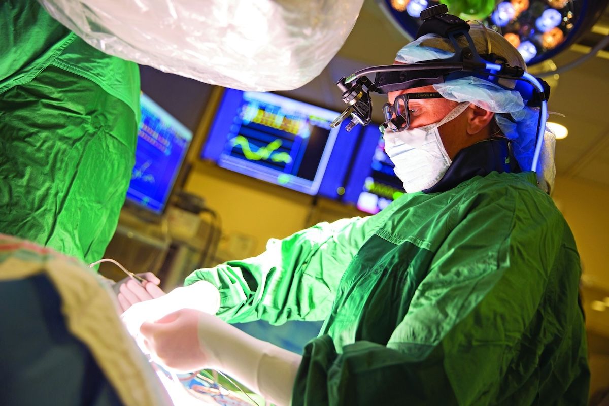 A surgeon performing surgery in an operating room