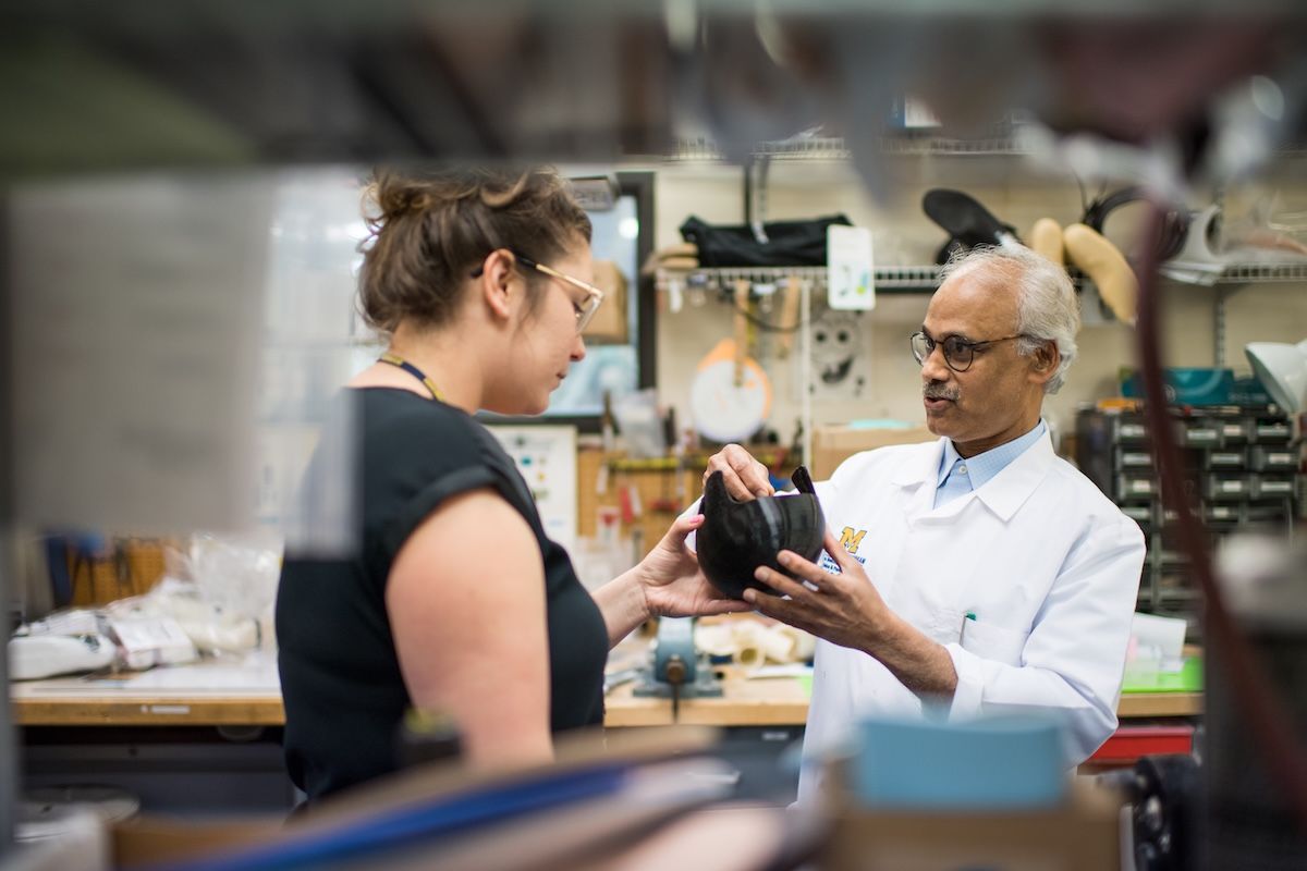 Ammanath Peethambaran showing someone the cranial helmet he developed for infants