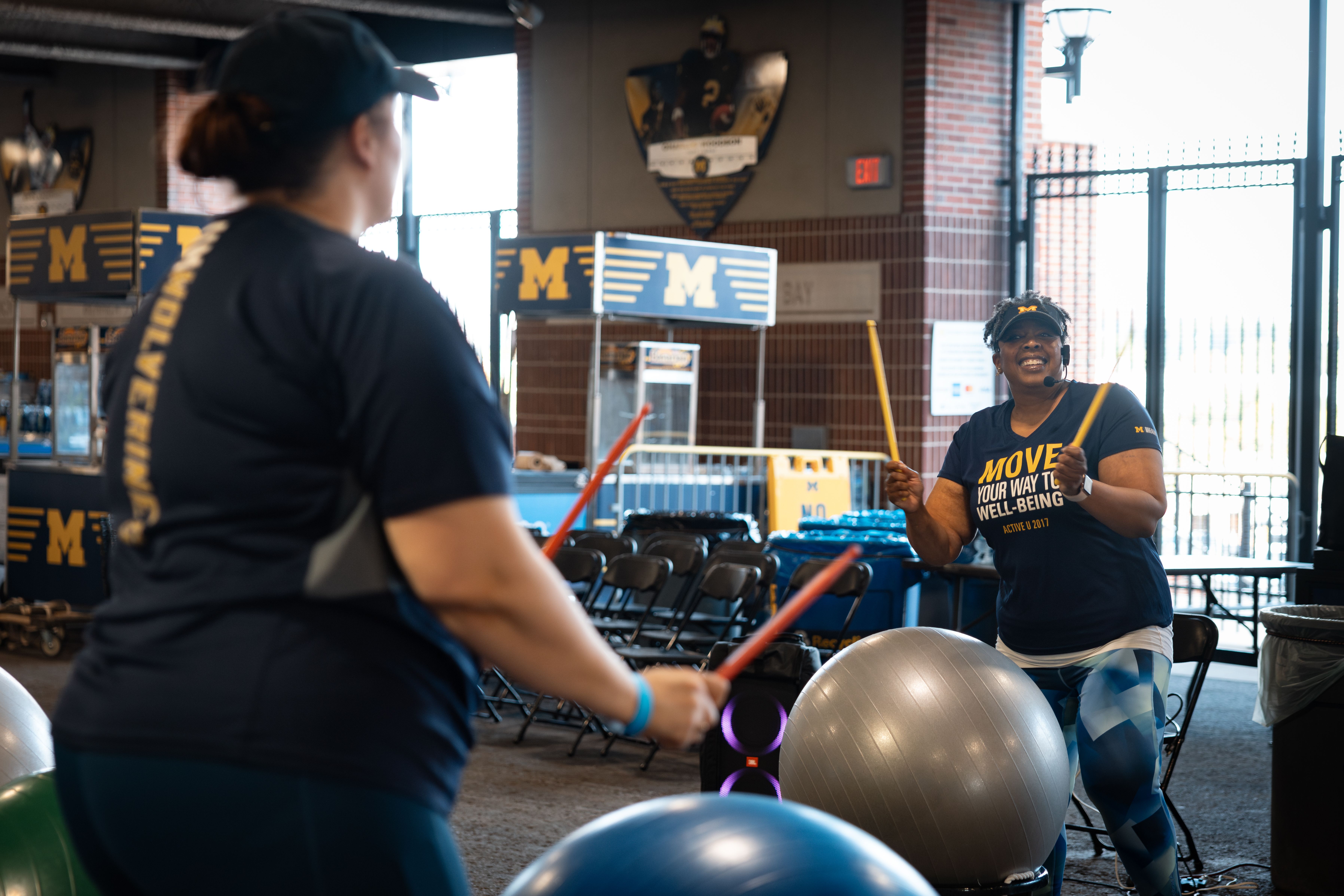 Students drumming on exercise balls