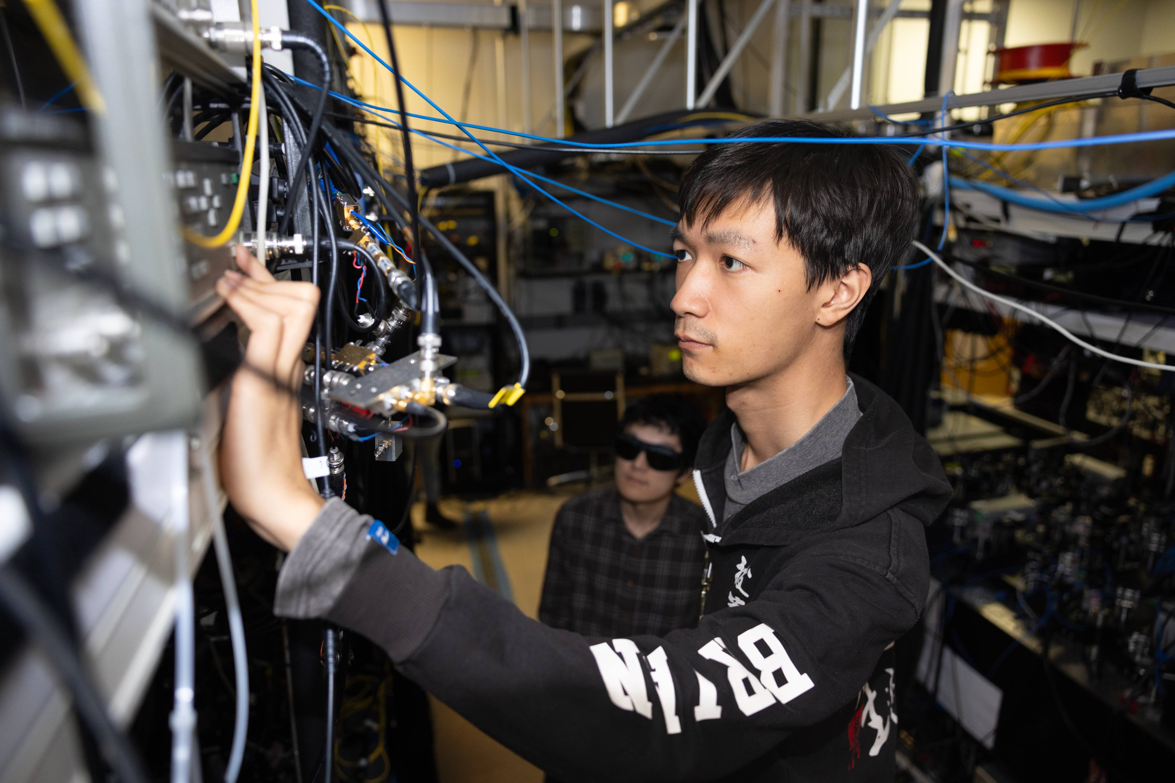 A person examining wiring on some equipment