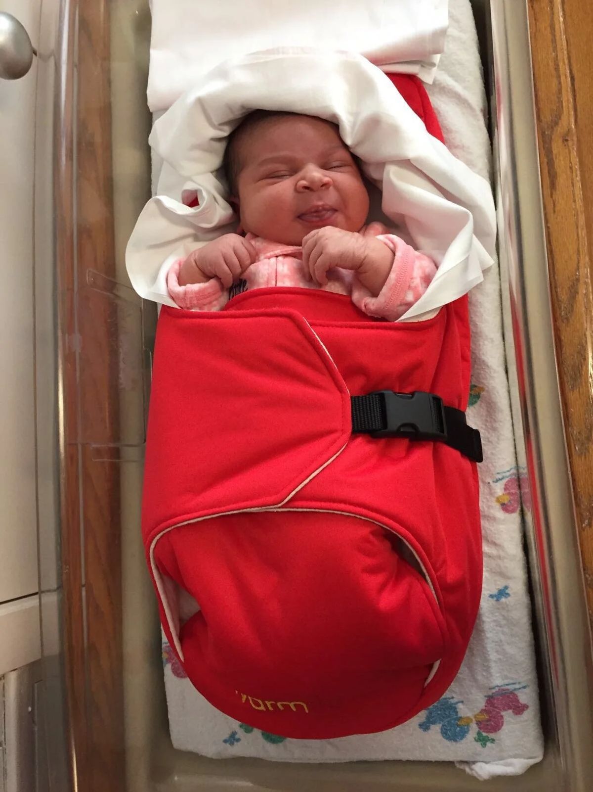 An infant wrapped in the Warmilu heating blanket