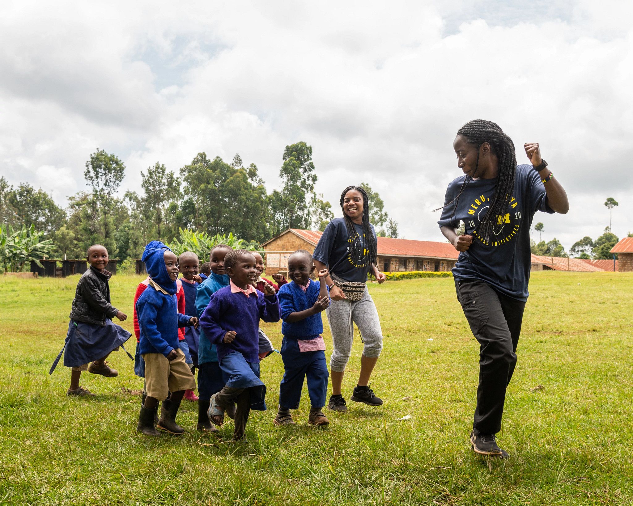 People leading a group of children on a study abroad assignment