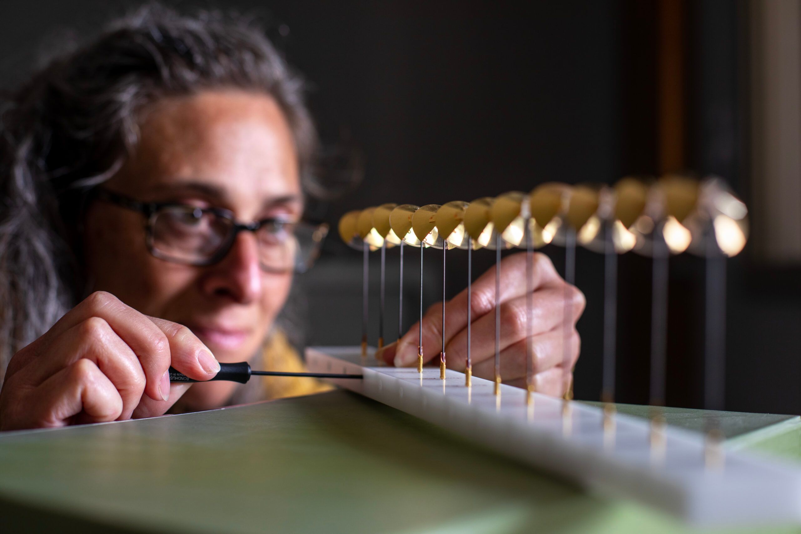 an engineer tinkers with some delicate vanes