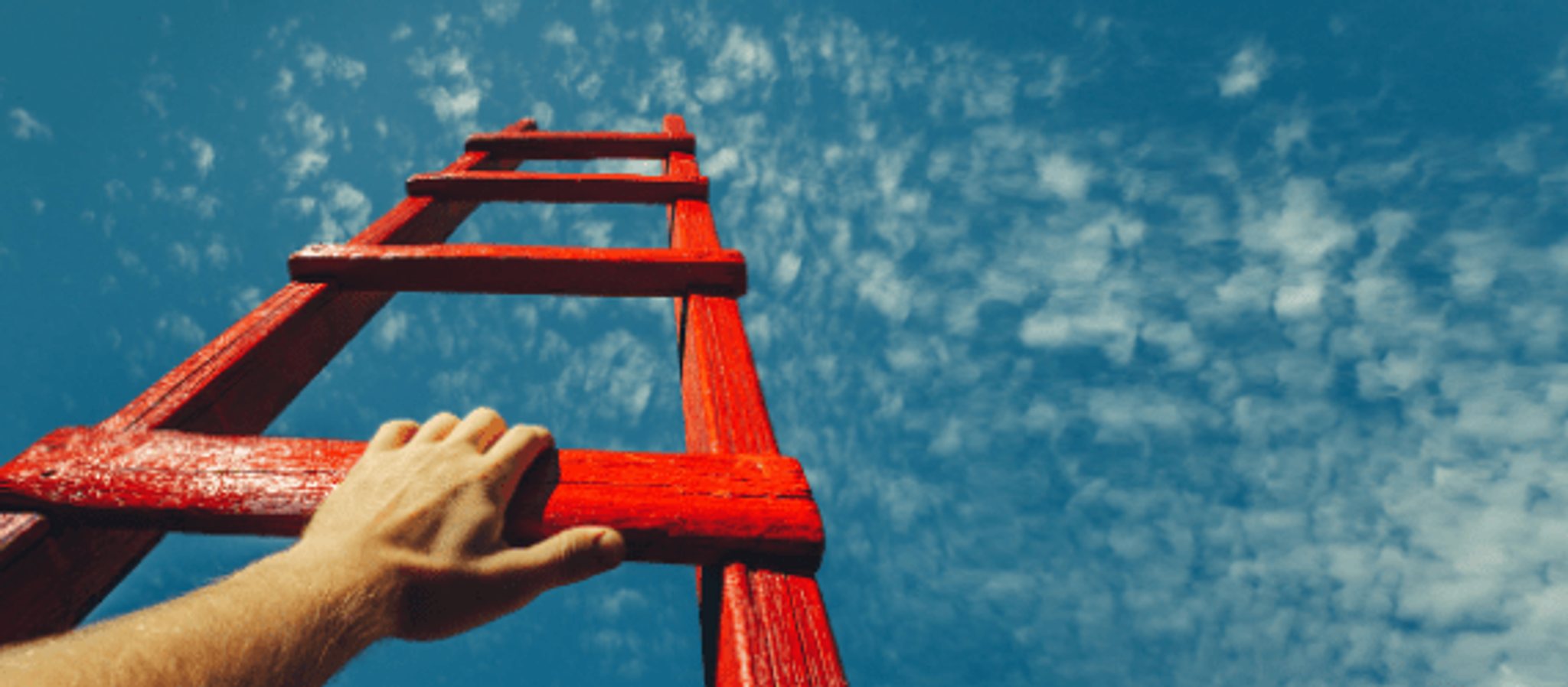 Hand Climbing Ladder up to Cloudy Sky