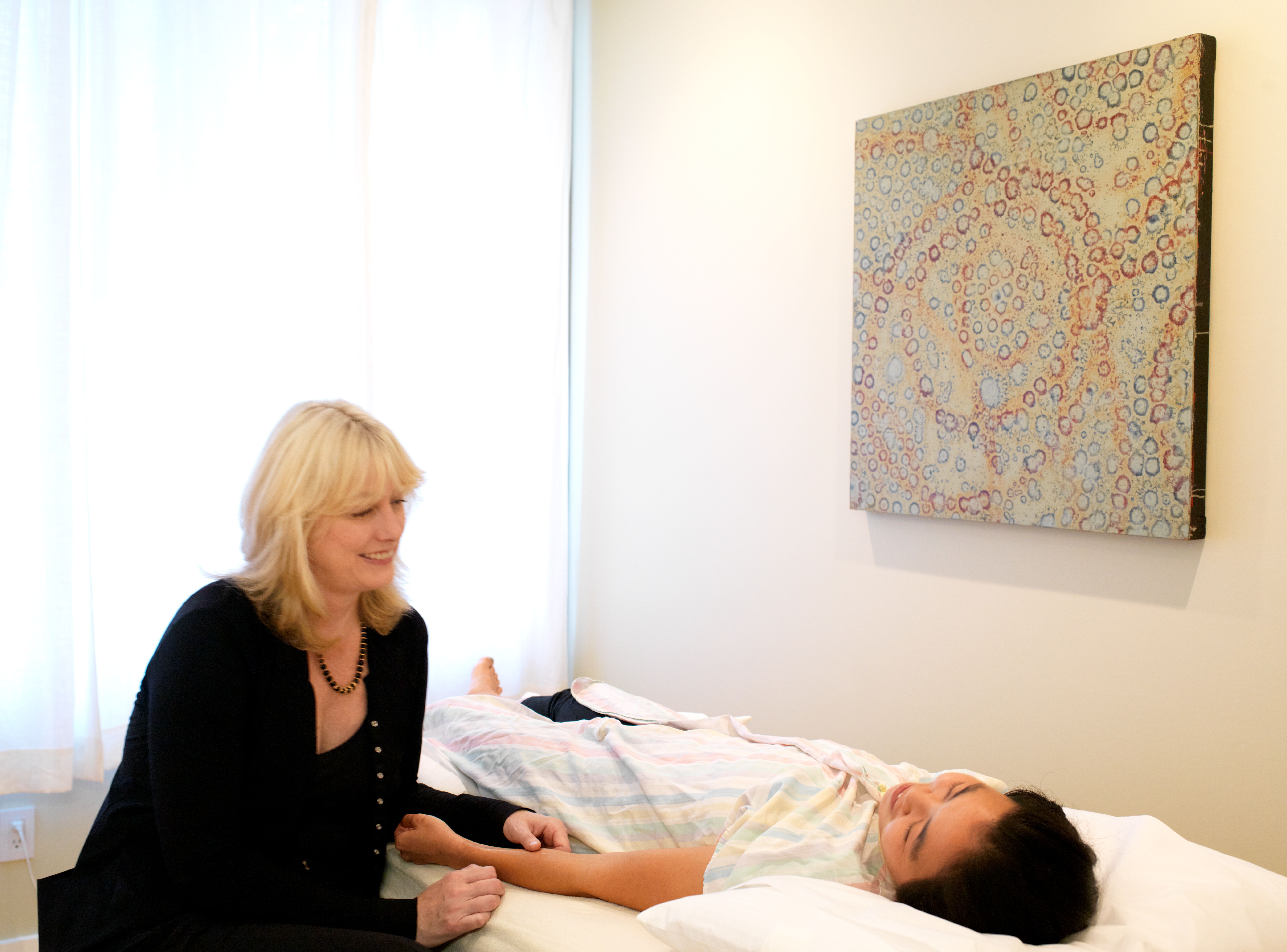 Taking a patient's pulse at the treatment table