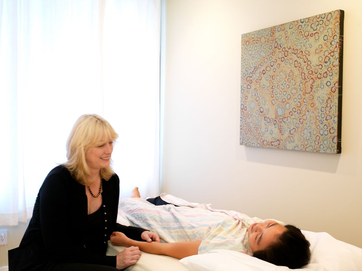 Taking a patient's pulse at the treatment table