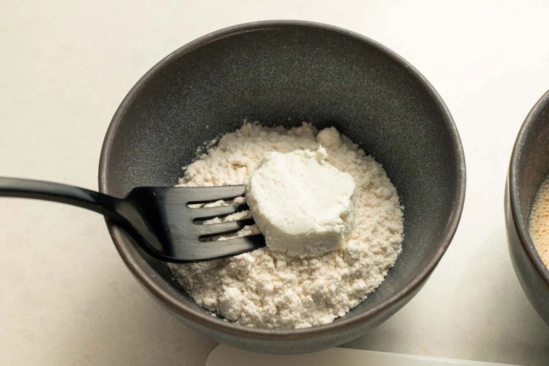 Dredging goats cheese in flour