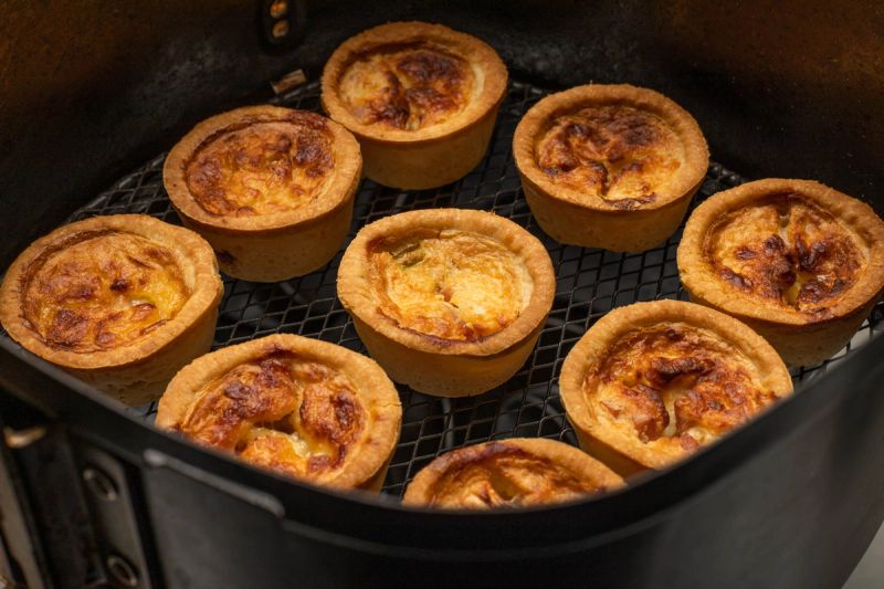 Air fried mini quiches in air fryer basket Air fried mini quiches in air fryer basket