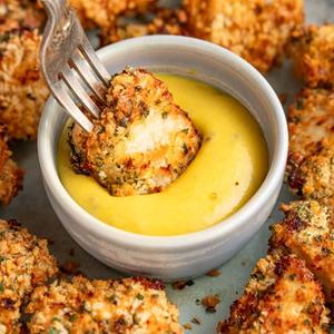 air fried chicken bites dipped into sweet mustard sauce