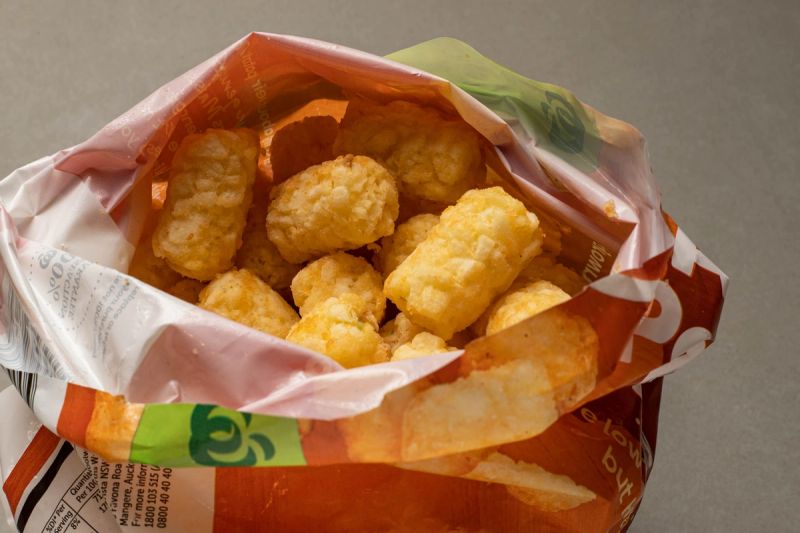 Opened bag of frozen potato gems. Opened bag of frozen potato gems.