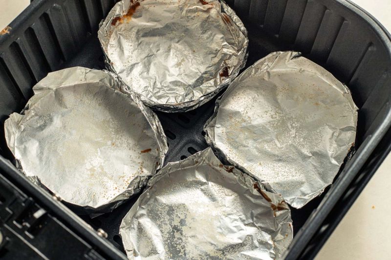 Empty foil trays in air fryer basket